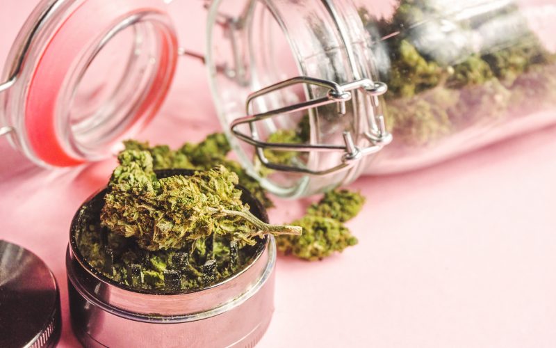 marijuana-flower-buds-glass-jar-grinder-on-pink-ba-2025-01-08-09-17-30-utc